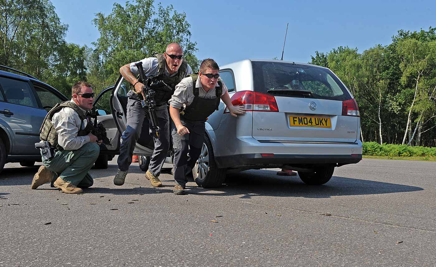 Military Police Close Protection personnel exiting a vehicle during training.