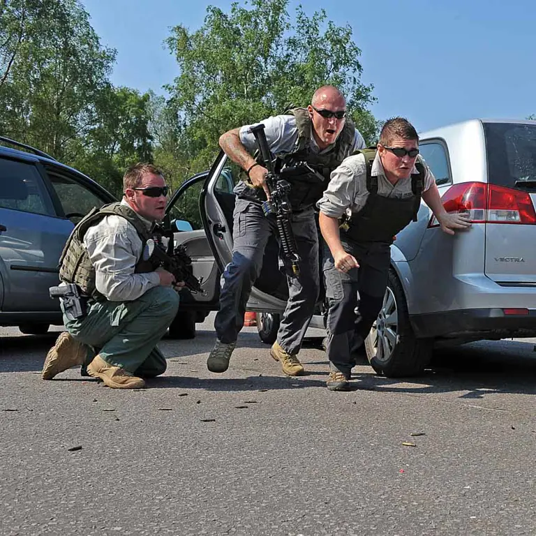 Military Police Close Protection personnel exiting a vehicle during training.