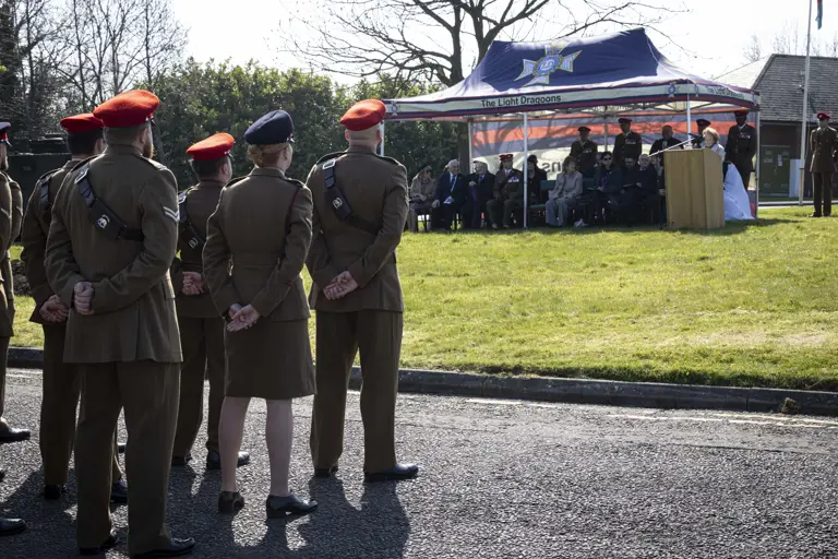 Members attending a special memorial service presented by The Light Dragoons sat under shelter on looked by several soldiers in their number 2 uniforms paying their respects.
