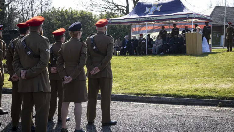 Members attending a special memorial service presented by The Light Dragoons sat under shelter on looked by several soldiers in their number 2 uniforms paying their respects.