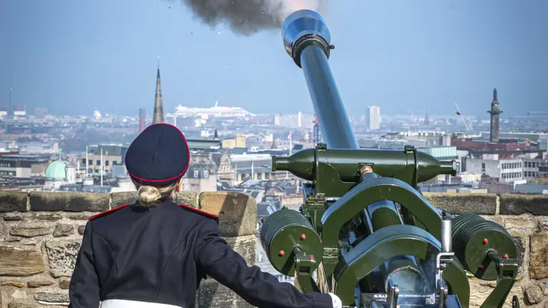 Caroline Gallagher is shown in No.1 dress uniform stood back to the camera having fired out the gun salute on top of Edinburgh Castle.