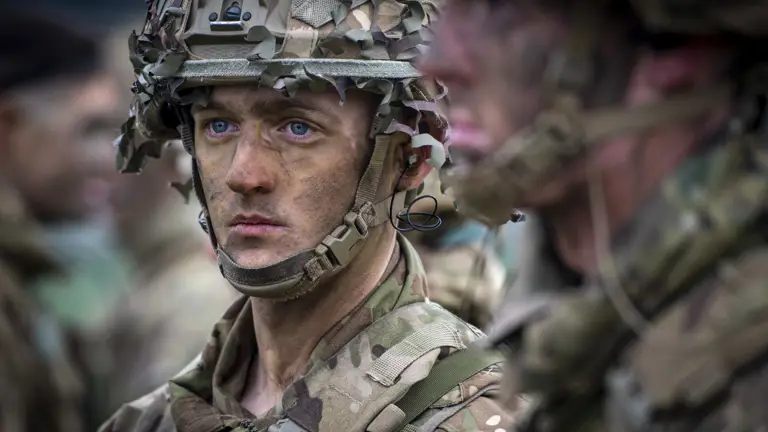 close up portrait of a soldiers wearing camouflage uniform and helmet.