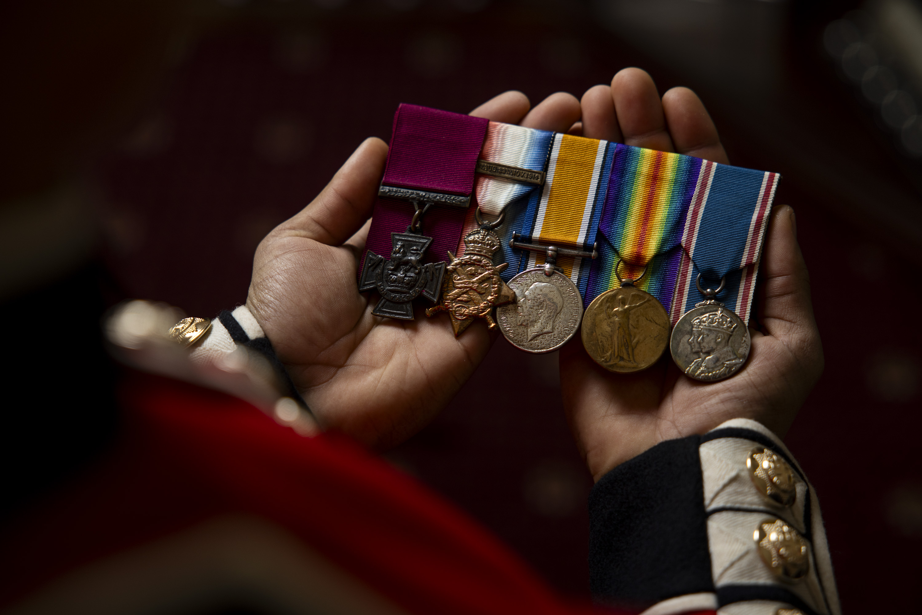Several medals are held on display.