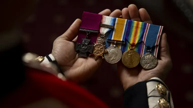 Several medals are held on display.